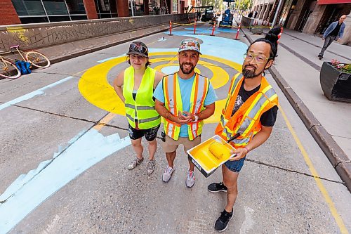 MIKE DEAL / FREE PRESS
(From left) Artist, Alex Plante, Stephen Dorge, project manager, and Takashi Iwasaki, artistic lead for the mural designs for a four-block stretch of Graham between Carlton and Garry Street Tuesday morning.
250708 - Tuesday, July 08, 2025.