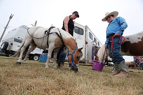 Cole Jacobson, right, and his mom feed their miniature horses during a day of competition at the Oak River Fair on Monday afternoon. (Matt Goerzen/The Brandon Sun)
