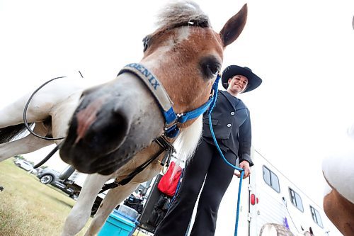 Adriana Jacobson from Minnedosa holds her 11-year-old minature horse, Phoenix, during feeding time at the Oak River Fair on Monday afternoon. (Matt Goerzen/The Brandon Sun)