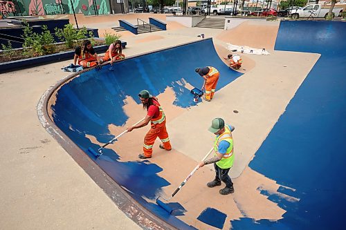 City of Brandon parks and recreation workers paint the bowl at the Kristopher Campbell Memorial Skate Plaza in downtown Brandon on Wednesday. The workers have been painting all the ledges, banks and transitions in preparation for the Skatepark Graffiti Jam event scheduled for the plaza on Aug. 2nd. The event, presented by the city and the Downtown BIZ, will feature music, food, skateboarding and graffiti artists creating murals within the skatepark. (Tim Smith/The Brandon Sun)