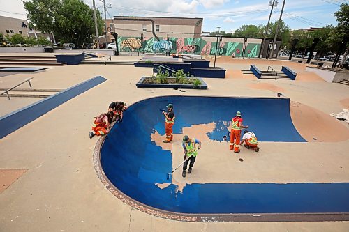 16072025
City of Brandon Parks and Recreation workers paint the bowl at the Kristopher Campbell Memorial Skate Plaza in downtown Brandon on Wednesday. The workers have been painting all the ledges, banks and transitions in preparation for the Skatepark Graffiti Jam event scheduled for the plaza on August 2nd. The event, presented by the City of Brandon and Brandon Downtown Biz will feature music, food, skateboarding and graffiti artists creating murals within the skatepark. 
(Tim Smith/The Brandon Sun)