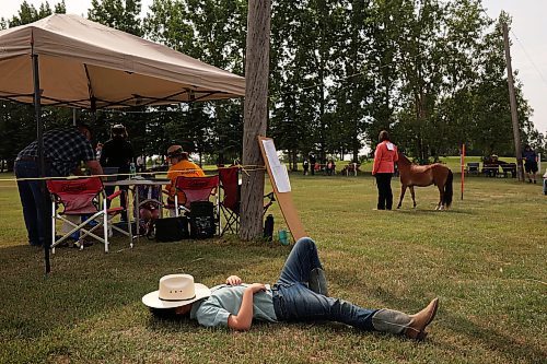 Cole Jacobson of Minnedosa relaxes in the grass outside the show ring. (Tim Smith/The Brandon Sun)