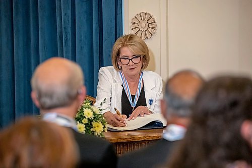 BROOK JONES/FREE PRESS
The Order of Manitoba, Manitoba's highest honour, was presented to 12 recipients during an investiture ceremony in the Manitoba Room at the Manitoba Legislative Building in Winnipeg, Man., Thursday, July 17, 2025. Pictured: Marion F. Willis, who has contributed to safer and healthier communities in Manitoba, signs the registry for the Order of Manitoba.