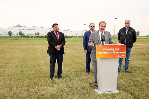 23072025
Agriculture Minister Ron Kostyshyn speaks as Municipal and Northern Relations Minister Glen Simard, Director of Operations for Canada Packers Inc. Rob Ackerblade and Maple Leaf Foods Plant Manager Jim Brown look on during an announcement by the province at Maple Leaf Foods near Brandon on Wednesday. The governments of Manitoba and Canada announced an investment of over $6 million for food processing facilities in Manitoba.
(Tim Smith/The Brandon Sun)