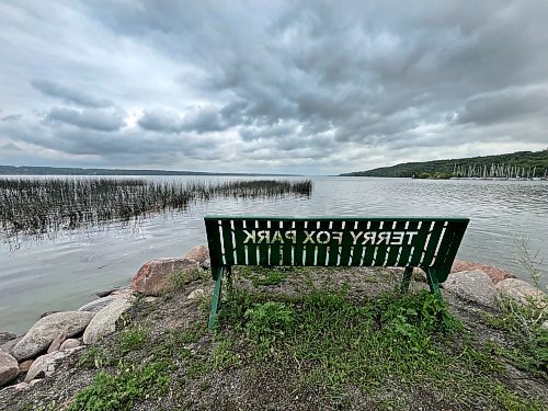 A bench looks out over the water on the shore of Pelican Lake in Ninette from Terry Fox Memorial Park on an overcast Tuesday afternoon. (Matt Goerzen/The Brandon Sun)