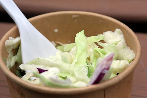 A small container of coleslaw accompanies a chicken ranch wrap at Hot 'N' Frosty in Ninette, the community's summer drive-in destination. (Matt Goerzen/The Brandon Sun)