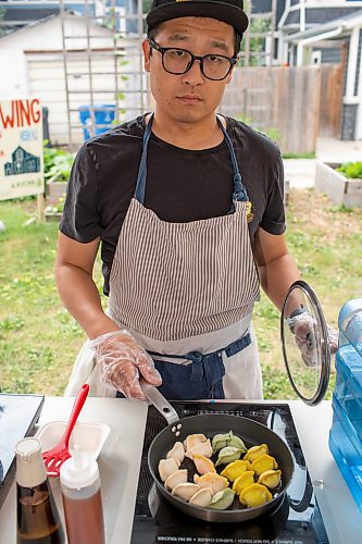 BROOK JONES/FREE PRESS
Aaron Li, who moved to Winnipeg with his family in 2022, markets Chinese dumplings based on family recipes and sells his dumplins at the Wolseley Farmers Market at Saint Margaret's Anglican Church in Winnipeg, Man. Li has a variety of dumplings such as pork with cabbage and chive, tofu with kimchi and beef with carrots and onion. Pictured: Li, 37, prepares dumplings on a portable induction cooktop at his Super Flying Dumpling booth during the Wolseley Farmers Market Tuesday, July 29, 2025.