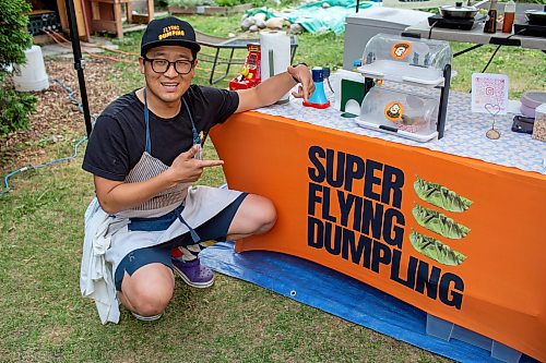 BROOK JONES/FREE PRESS
Aaron Li, who moved to Winnipeg with his family in 2022, markets Chinese dumplings based on family recipes and sells his dumplins at the Wolseley Farmers Market at Saint Margaret's Anglican Church in Winnipeg, Man. Li has a variety of dumplings such as pork with cabbage and chive, tofu with kimchi and beef with carrots and onion. Pictured: Li, 37, shows enthusiasm for his Super Flying Dumpling booth during the Wolseley Farmers Market Tuesday, July 29, 2025.