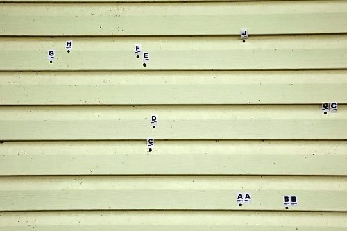 30072025
Bullet holes are marked by RCMP investigators in the side of a home on Keeseekoowenin First Nation after 33-year-old Vanessa Bone was murdered and a 26-year-old man injured in a targeted shooting early Monday. Family and friends are tending to a sacred fire for four days at the home according to tradition. 
(Tim Smith/The Brandon Sun)
