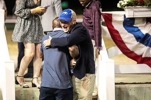 MIKAELA MACKENZIE / FREE PRESS
	
Attack trainer Craig Robert Smith, who won after Take Charge Tom was disqualified, celebrates by hugging Steve Gaskin at the Manitoba Derby at the Assiniboia Downs on Monday, Aug. 4, 2025. 

For photo page.
Winnipeg Free Press 2025