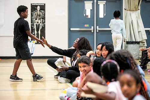 MIKAELA MACKENZIE / FREE PRESS
	
Aminadab Berhe (going into grade five) high-fives instructor Grace Adio after getting a participation certificate at the CSI Summer Learning Enrichment Program graduation ceremony at Sister MacNamara on Wednesday, Aug. 6, 2025. The CSI program offers educational and recreational programming for five weeks in the summer.

Standup.
Winnipeg Free Press 2025