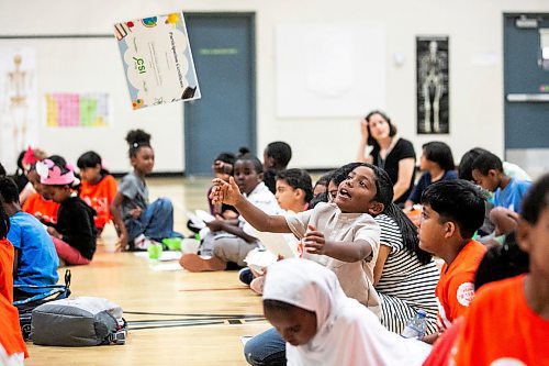 MIKAELA MACKENZIE / FREE PRESS
	
Afiq Mohd Tokim (going into grade three) throws his participation certificate into the air at the CSI Summer Learning Enrichment Program graduation ceremony at Sister MacNamara on Wednesday, Aug. 6, 2025. The CSI program offers educational and recreational programming for five weeks in the summer.

Standup.
Winnipeg Free Press 2025