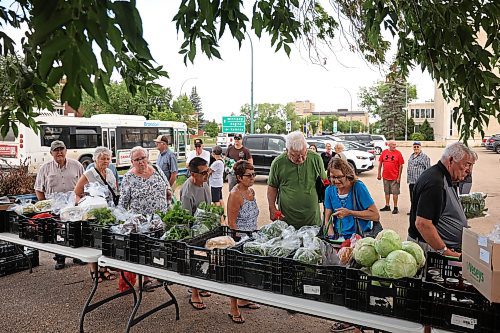 06082025
Customers shop for fresh produce, bread, pies and other goods at Spring Valley Colony’s weekly summer produce market on 18th Street in the BellMTS Admin Building parking lot, Wednesday. A crowd was already waiting as colony members set up the market. Julie Waldner, the Head Gardener at Spring Valley sees both regular weekly customers as well as new faces. The market ran from 12PM and included a wide assortment of vegetables including cucumbers, beans, lettuce, garlic, broccoli, zucchini, beets and much more. (Tim Smith/The Brandon Sun)