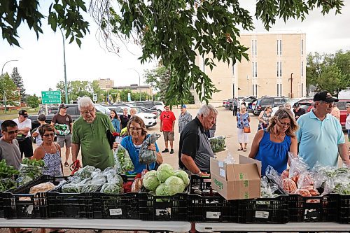 06082025
Customers shop for fresh produce, bread, pies and other goods at Spring Valley Colony’s weekly summer produce market on 18th Street in the BellMTS Admin Building parking lot, Wednesday. A crowd was already waiting as colony members set up the market. Julie Waldner, the Head Gardener at Spring Valley sees both regular weekly customers as well as new faces. The market ran from 12PM and included a wide assortment of vegetables including cucumbers, beans, lettuce, garlic, broccoli, zucchini, beets and much more. (Tim Smith/The Brandon Sun)