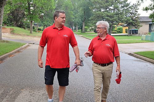 Spruce Woods Liberal candidate Stephen Reid (left) and Manitoba Liberal president Terry Hayward campaign along Kensington Crescent in Brandon's North Hill on Friday. (Alex Lambert/The Brandon Sun)