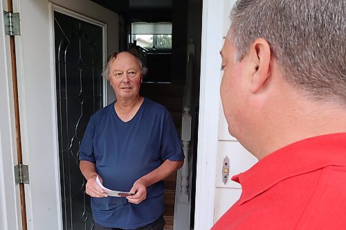 Spruce Woods Liberal candidate Stephen Reid (right) speaks with voter Stu Ford outside of Ford's home in Brandon's North Hill. (Alex Lambert/The Brandon Sun)