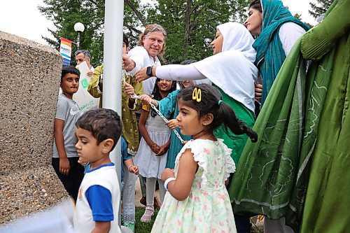 14082025
Members of Brandon’s Pakistani community raise the Pakistan flag at Brandon City Hall on Thursday along with Brandon Mayor Jeff Fawcett to celebrate Pakistan’s Independence Day.
(Tim Smith/The Brandon Sun)