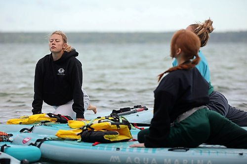 15082025
Freja Cuddington (L) takes part in a paddleboard Yin yoga class on Clear Lake at Spruces in Riding Mountain National Park with fellow yoga enthusiasts on Friday morning. A crystal sound bowl class was held on land following the yoga. The classes, offered by Paddle Bros, run four days a week for one more week and three classes were scheduled for Friday. Summer classes began at Minnedosa Lake but moved up to Clear Lake after the water advisory was issued At Minnedosa.
(Tim Smith/The Brandon Sun)