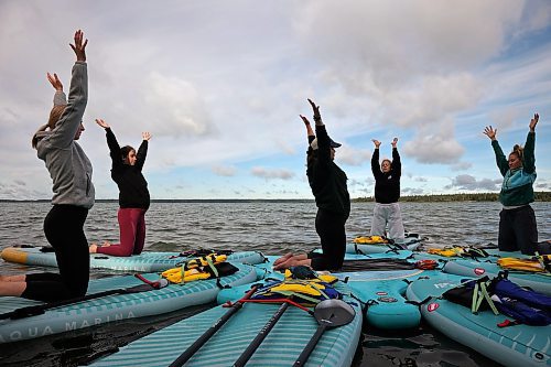 15082025
Barb Patten (C) leads a paddleboard Yin yoga class on Clear Lake at Spruces in Riding Mountain National Park on Friday morning. A crystal sound bowl class was held on land following the yoga. The classes, offered by Paddle Bros, run four days a week for one more week and three classes were scheduled for Friday. Summer classes began at Minnedosa Lake but moved up to Clear Lake after the water advisory was issued At Minnedosa.
(Tim Smith/The Brandon Sun)