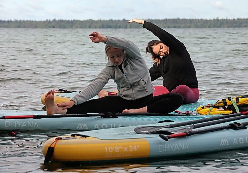 15082025
Riley Jonasson and Alyssa Fardoe part in a paddleboard Yin yoga class on Clear Lake at Spruces in Riding Mountain National Park with fellow yoga enthusiasts on Friday morning. A crystal sound bowl class was held on land following the yoga. The classes, offered by Paddle Bros, run four days a week for one more week and three classes were scheduled for Friday. Summer classes began at Minnedosa Lake but moved up to Clear Lake after the water advisory was issued At Minnedosa.
(Tim Smith/The Brandon Sun)