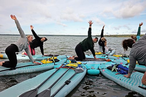 15082025
Barb Patten (C) leads a paddleboard Yin yoga class on Clear Lake at Spruces in Riding Mountain National Park on Friday morning. A crystal sound bowl class was held on land following the yoga. The classes, offered by Paddle Bros, run four days a week for one more week and three classes were scheduled for Friday. Summer classes began at Minnedosa Lake but moved up to Clear Lake after the water advisory was issued At Minnedosa.
(Tim Smith/The Brandon Sun)