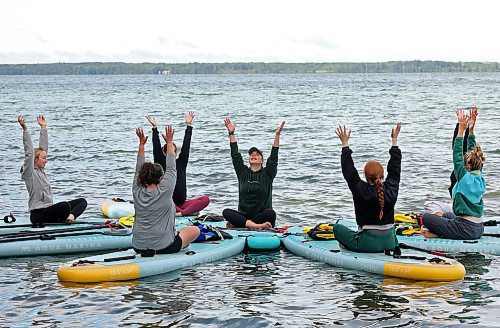 15082025
Barb Patten (C) leads a paddleboard Yin yoga class on Clear Lake at Spruces in Riding Mountain National Park on Friday morning. A crystal sound bowl class was held on land following the yoga. The classes, offered by Paddle Bros, run four days a week for one more week and three classes were scheduled for Friday. Summer classes began at Minnedosa Lake but moved up to Clear Lake after the water advisory was issued At Minnedosa.
(Tim Smith/The Brandon Sun)