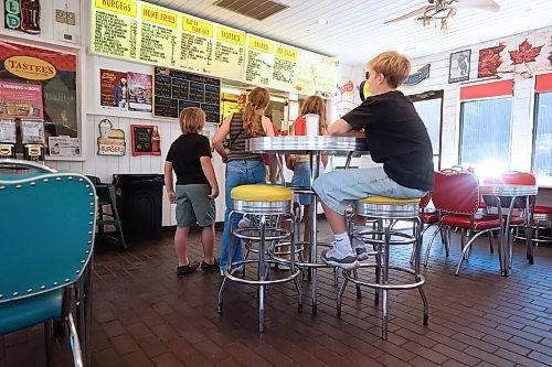 A group of kids have a look at the menu inside Tastee's Ice Cream and Grill on Friday afternoon. (Matt Goerzen/The Brandon Sun)