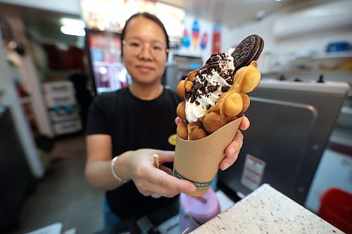 Tastee's Ice Cream and Grill co-owner Claudia Leung offers up her business's signature ice cream dish, a unique egg waffle ice cream treat from Hong Kong that was introduced a few years ago. The treat sports a bulbous crunchy waffle topped with your choice of soft serve ice cream and toppings. (Matt Goerzen/The Brandon Sun)
