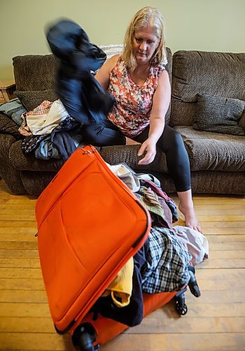 JOHN WOODS / FREE PRESS
Bonnie Bradley, who was supposed to be home Friday, but missed her connecting flight from Montreal to Winnipeg because of the job action by Air Canada flight attendants unpacks her luggage in her home in Winnipeg Monday, August 18, 2025. Bradley and her mother took a bus to Ottawa and then rented a car which they drove to Sault St Marie where they met her sons and then drove to Winnipeg.

Reporter: nicole
