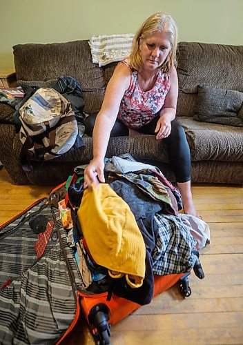 JOHN WOODS / FREE PRESS
Bonnie Bradley, who was supposed to be home Friday, but missed her connecting flight from Montreal to Winnipeg because of the job action by Air Canada flight attendants unpacks her luggage in her home in Winnipeg Monday, August 18, 2025. Bradley and her mother took a bus to Ottawa and then rented a car which they drove to Sault St Marie where they met her sons and then drove to Winnipeg.

Reporter: nicole