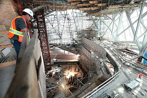 A PCL worker looks over one of the viewing areas out into the  "Cloud" a giant glass structure that surrounds the upper floors of the museum Wednesday morning. Earlier building crews working on the Canadian Museum of Human Righs hoisted  the final piece of glass up to the chimney area of the Tower of Hope  which is 328 feet high on Wednesday morning. See Story Sept 20,  2012 (Ruth Bonneville/Winnipeg Free Press) CMHR