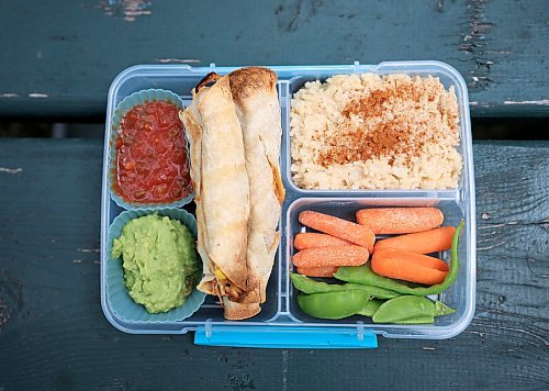 Ruth Bonneville / Free Press
ENT - Lunchbox Chopped
Photo of lunchbox 2 by Sophie Fiola (white apron) - Chicken, bean and corn taquitos with salsa and guacamole, served with a side of carrots and sweet peas, with a horchata-inspired rice pudding for dessert
Photos for a feature on 3 local chefs presenting their lunchbox for 3 children to taste test and judge. The kids and chefs met at a picnic table at Assiniboine Park for the lunchbox taste-testing event.
Names Children taste testing in photos. (First names only)
Blonde child with glasses: Paislee, 8
Dark brown hair,, overalls, glasses Faith, 9
Child with colourful braids: Aria, 10
Names of Chefs + lunches:
1. Sophie Fiola (white apron) - Chicken, bean and corn taquitos with salsa and guacamole, served with a side of carrots and sweet peas, with a horchata-inspired rice pudding for dessert
2. Sharron Park - red lentil buns and WAITING ON THE SOUP DETAILS with seasonal fruit crumble
3. Elisa de Jesus – she was not at the shoot but she made a lunch which was red lentil fritters with quinoa salad and oatmeal raisin cookies
The story is for Weds 27 August.
See AV Kitching for more info and story
Aug 11th, 2025