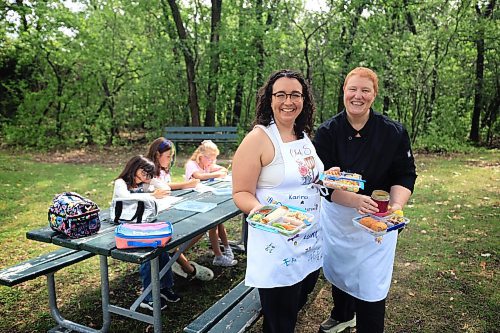 Ruth Bonneville / Free Press
ENT - Lunchbox Chopped
Photo of chefs, Sophie Fiola (left) and Sharron Park before presenting their lunches.
Photos for a feature on 3 local chefs presenting their lunchbox for 3 children to taste test and judge. The kids and chefs met at a picnic table at Assiniboine Park for the lunchbox taste-testing event.
Names Children taste testing in photos. (First names only)
Blonde child with glasses: Paislee, 8
Dark brown hair,, overalls, glasses Faith, 9
Child with colourful braids: Aria, 10
Names of Chefs + lunches:
1. Sophie Fiola (white apron) - Chicken, bean and corn taquitos with salsa and guacamole, served with a side of carrots and sweet peas, with a horchata-inspired rice pudding for dessert
2. Sharron Park - red lentil buns and WAITING ON THE SOUP DETAILS with seasonal fruit crumble
3. Elisa de Jesus – she was not at the shoot but she made a lunch which was red lentil fritters with quinoa salad and oatmeal raisin cookies
The story is for Weds 27 August.
See AV Kitching for more info and story
Aug 11th, 2025