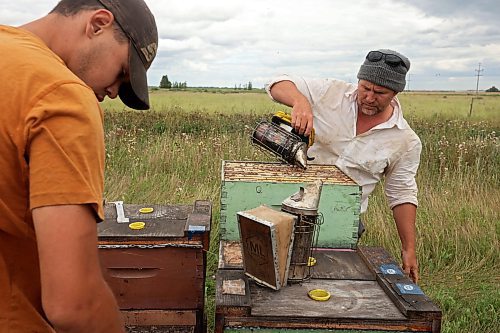 22082025
Mike Clark with Clark Apiaries (R) and Richard Gradwell (L) collect honey boxes from nucleus hives north of Wawanesa along Provincial Road 340 on a cool Friday afternoon, so they can extract the honey. Nucleus hive’s are smaller starter hives and don’t produce a lot of honey. They will be fully productive next year. Clark is a third generation beekeeper. His grandfather started the apiary in 1914. Clark is the Director of the Manitoba Beekeepers’ Association. (Tim Smith/The Brandon Sun)