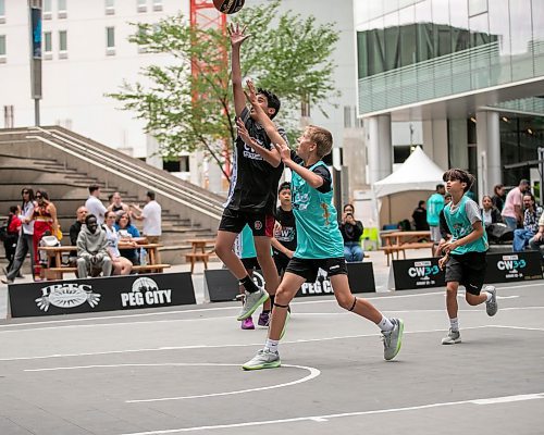 BROOK JONES/FREE PRESS
The Canadian Elite Basketball League is hosting a three-day fan-focused street festival as part of the 2025 Championship Weekend at True North Square and on Graham Avenue between Edmonton St. and Donald St. in Winnipeg, Man. Pictured: Team South player Aikam Litt and Team Westside player Amir Hashmi challenge each other for the basketball while competing in 3x3 basketball on Friday, Aug. 22, 2025.