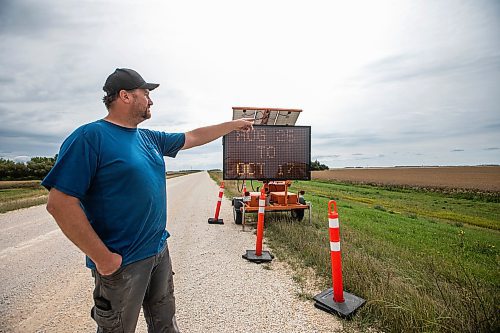 MIKAELA MACKENZIE / FREE PRESS
	
Dustin Wiens, a grain farmer south of La Salle, by the road closure of Floodway Road on Monday, Aug. 25, 2025. The road, which is closed now through to October, will impact the way that he transports his harvest from the fields.

For Aaron story.
Free Press 2025