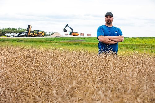 MIKAELA MACKENZIE / FREE PRESS
Dustin Wiens, a grain farmer south of La Salle, in his canola field by the road closure of Floodway Road on Monday, Aug. 25, 2025. The road, which is closed now through to October, will impact the way that he transports his harvest from the fields.
For Aaron story.
Free Press 2025