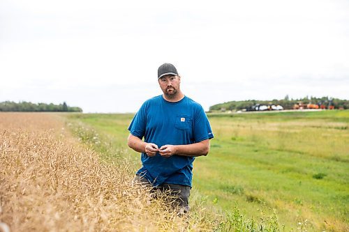 MIKAELA MACKENZIE / FREE PRESS
Dustin Wiens, a grain farmer south of La Salle, in his canola field by the road closure of Floodway Road on Monday, Aug. 25, 2025. The road, which is closed now through to October, will impact the way that he transports his harvest from the fields.
For Aaron story.
Free Press 2025