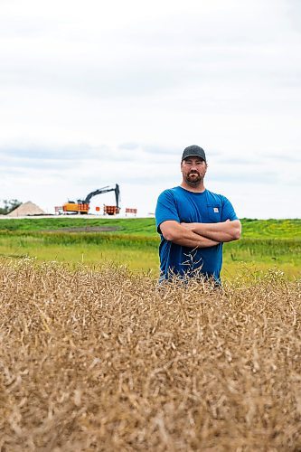 MIKAELA MACKENZIE / FREE PRESS
Dustin Wiens, a grain farmer south of La Salle, in his canola field by the road closure of Floodway Road on Monday, Aug. 25, 2025. The road, which is closed now through to October, will impact the way that he transports his harvest from the fields.
For Aaron story.
Free Press 2025
