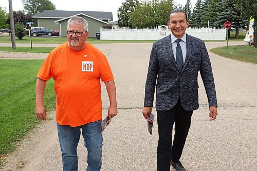 Spruce Woods NDP candidate Ray Berthelette and Manitoba Premier Wab Kinew walk together in Rivers to knock on doors and meet voters on Monday in the final push ahead of today’s Spruce Woods byelection. (Tim Smith/The Brandon Sun)