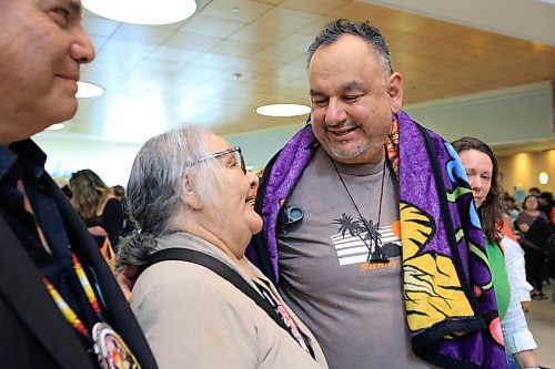 Ruth Bonneville / Free Press 
LOCAL - 60's scoop airport reunion 
Photo of Jonathan Hooker gets emotional as he meets  his biological mom. Patsy George for the 1st time after many years at the airport Wednesday.
Jonathan Hooker, who was taken from his family in Northern Manitoba in the 1970s, arrives with his wife Charmaine Hooker (green vest) after travelling from their home in New Zealand to meet his biological mom, Patsy George and family at the  James Richardson Winnipeg International Airport Wednesday. 
Story info: He’s one of an estimated 30,000 Indigenous children taken from their homes during what has become known as the Sixties Scoop.  A time period that spanned from 1951-1991. Jonathan was adopted by a white middle-class family in Manitoba, and they moved to New Zealand.  
A big welcome party took place with Drummers and Indigenous leaders, family and friends  to celebrate his return home.    His birth mom, Patsy George with her sister, Flora McNabb (grey sweater), granddaughter Nellie McNabb (rust shirt) and many other family members and friends gather at the airport.
Aug 27th,  2025