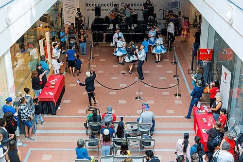MIKE DEAL / FREE PRESS
Kevin Chief holds a baby while dancing with the Norman Chief Memorial Dancers who were part of the entertainment during a “Love Your Downtown” community celebration event at Portage Place hosted by True North Real Estate Development (TNRED). The Wednesday afternoon event drew crowds to the mall which is still open for business during the construction of the Healthcare Centre of Excellence in the east block. Several community leaders dropped by to chat with people and take in the entertainment which included hoop dancers, and a fashion show.
250827 - Wednesday, August 27, 2025.