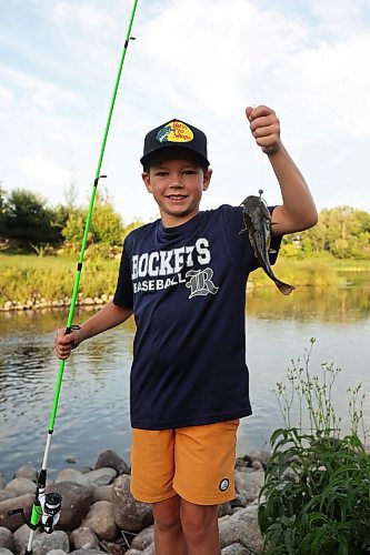 26082025
Preston Harris holds a freshly caught fish while fishing from the bank of Plum Creek in Souris with friends from the Homegrown Hockey Camp on a warm Tuesday evening. (Tim Smith/The Brandon Sun)