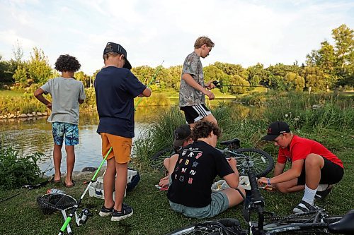 26082025
A group of boys all taking part in the Homegrown Hockey Camp in Souris fish along Plum Creek near where it enters the Souris River in Victoria Park on a warm Tuesday evening. (Tim Smith/The Brandon Sun)