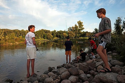 26082025
A group of boys all taking part in the Homegrown Hockey Camp in Souris fish along Plum Creek near where it enters the Souris River in Victoria Park on a warm Tuesday evening. (Tim Smith/The Brandon Sun)