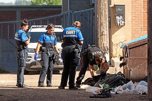 27082025
Brandon Community Cadets and a Brandon Police Service member look through garbage outside a dumpster in an alley north of Rosser Avenue between 9th Street and 10th Street in Brandon on Wednesday morning. BPS members responded to a gun allegedly being fired in the apartment building. (Tim Smith/The Brandon Sun)