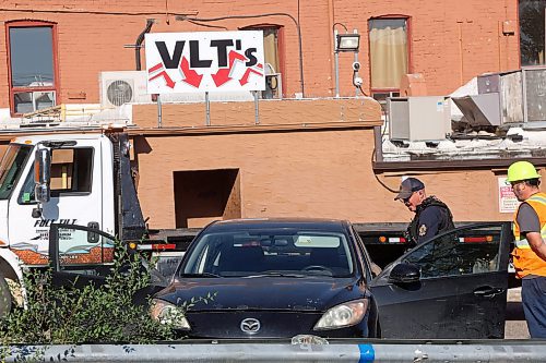 27082025
A Brandon Police service member looks through a car parked at the Crystal Hotel in Brandon on Wednesday morning. (Tim Smith/The Brandon Sun)