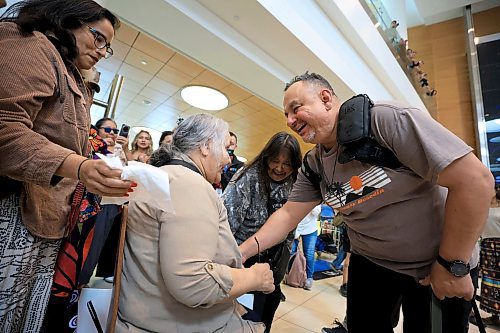 Ruth Bonneville / Free Press 
LOCAL - 60's scoop airport reunion 
Photo of Jonathan Hooker gets emotional as he meets  his biological mom. Patsy George for the 1st time after many years at the airport Wednesday.
Jonathan Hooker, who was taken from his family in Northern Manitoba in the 1970s, arrives with his wife Charmaine Hooker (green vest) after travelling from their home in New Zealand to meet his biological mom, Patsy George and family at the  James Richardson Winnipeg International Airport Wednesday. 
Story info: He’s one of an estimated 30,000 Indigenous children taken from their homes during what has become known as the Sixties Scoop.  A time period that spanned from 1951-1991. Jonathan was adopted by a white middle-class family in Manitoba, and they moved to New Zealand.  
A big welcome party took place with Drummers and Indigenous leaders, family and friends  to celebrate his return home.    His birth mom, Patsy George with her sister, Flora McNabb (grey sweater), granddaughter Nellie McNabb (rust shirt) and many other family members and friends gather at the airport.
Aug 27th,  2025