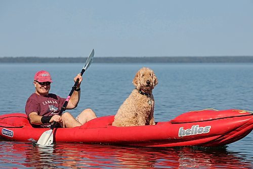 Mike Kusyk and his dog, Dasha, paddle on Clear Lake in Riding Mountain National Park on a hot and sunny Thursday afternoon. Environment Canada is forecasting a high today of 32 C for Brandon, followed by temperatures in the low 30s for most of the long weekend. (Tim Smith/The Brandon Sun)