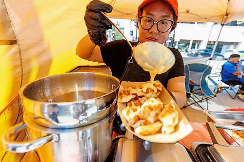 MIKE DEAL / FREE PRESS
Hannah Nguyen and Alain Pham at their station, Toasty Alley, a two-month old operation that sells croffles - a cross between croissants and waffles. The dish was created around 2018 in Korea, and has since spread around the world. Hannah and Alain (married) offer different flavours, including s'mores, pistachio and bacon-and-onions.
Reporter: Dave Sanderson
250828 - Thursday, August 28, 2025.